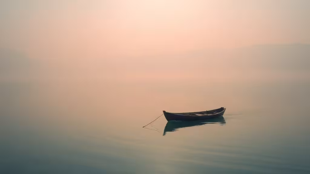 Citation sur le lâcher prise symbolisée par un bateau dérivant paisiblement sur un lac